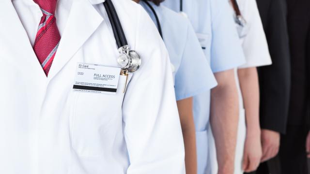 ID card on a white coat with stethoscope along with others as well as business suits.