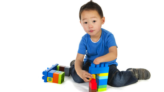 A child playing with giant legos.