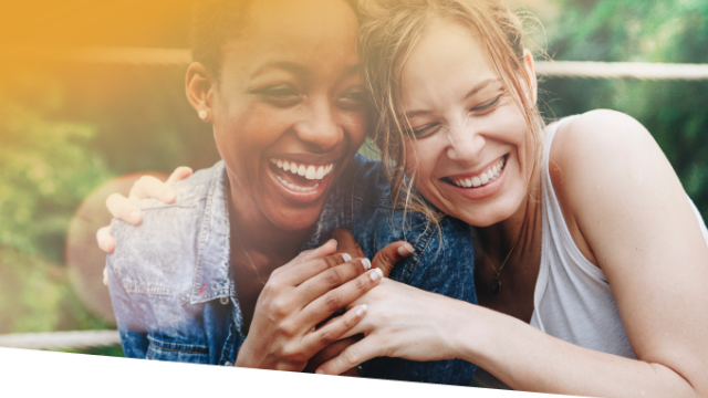 Two adults smiling and laughing