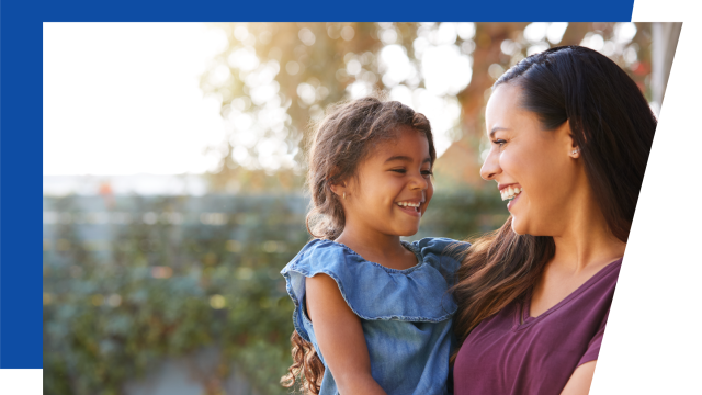 Laughing adult holding a laughing child