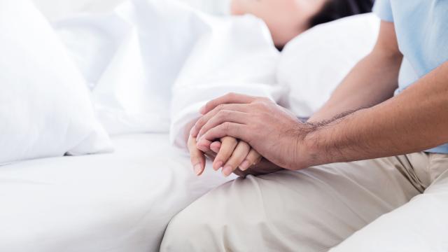 Adult holding hand of a sick person