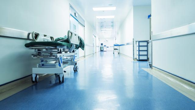 Hospital hallway with a hospital bed against a wall