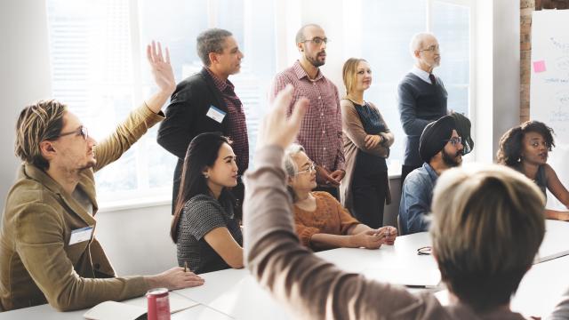 Group of people some with raised hands