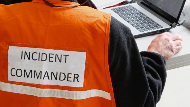 Incident Commander on back of orange safety vest.