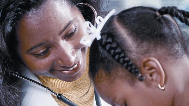 A doctor examining a young patient.