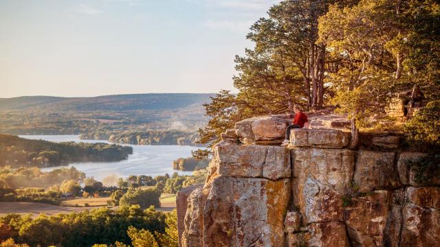 Adult sitting on Gibraltar Rock in Wisconsin