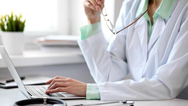 A laptop is used by a doctor.
