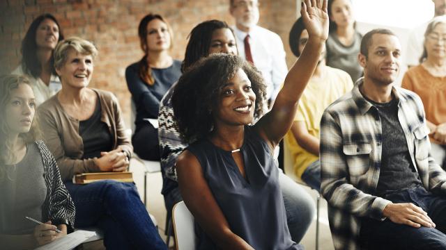 One adult raised hand in a seminar