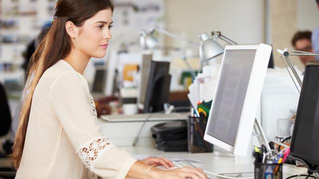 An adult working on a computer.