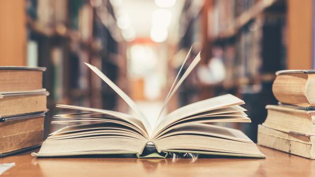 An opened book on a table in a library.