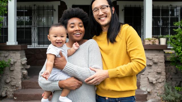 Family standing in front of their porch