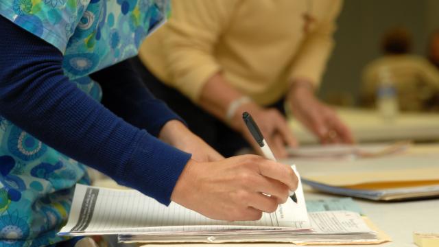 Two nurses completing paperwork.