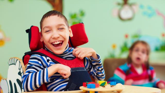 Laughing child in a wheelchair