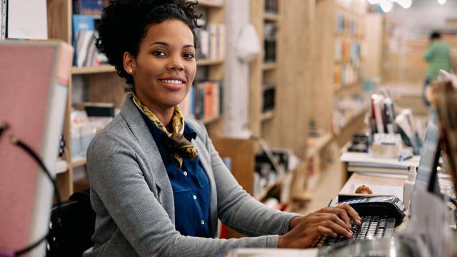 Adult at a computer at a book store