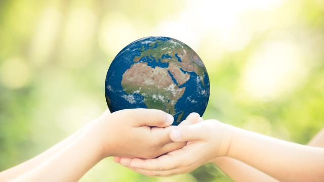 Two children holding the earth in their hands