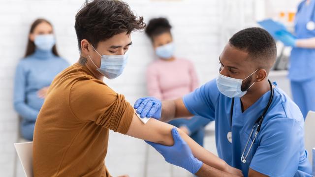 Young adult being inoculated at a vaccine clinic