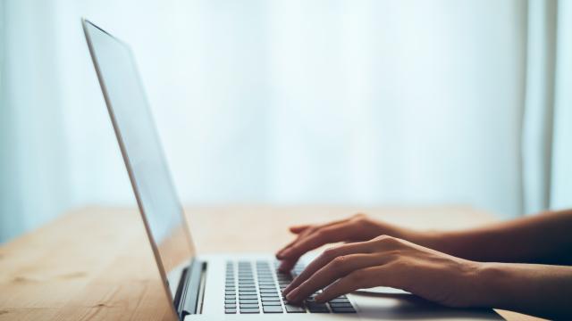 Adult hands typing on a laptop