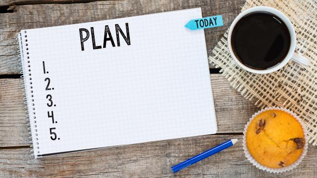 Planning notebook with numbers on the side, coffee cup and muffin on the side with a blue pencil