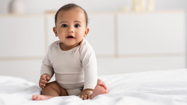 Baby sitting on a blanket