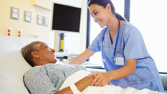 Nurse talking with patient in hospital room