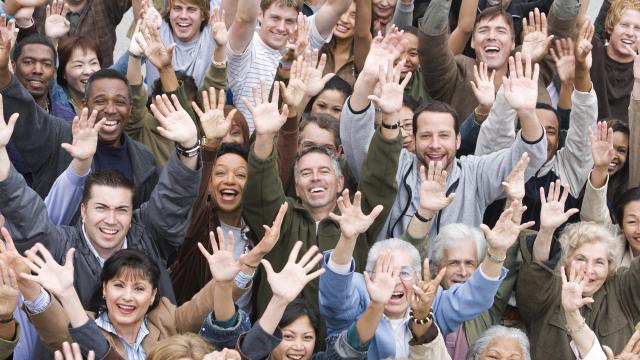 A smiling crowd wave.