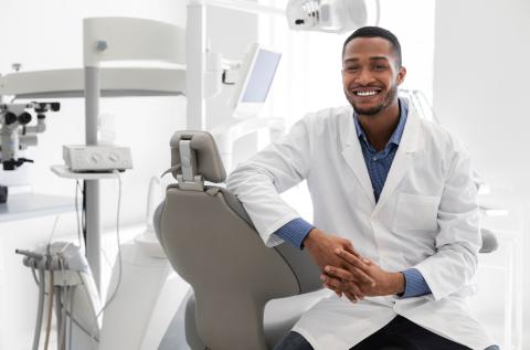 Smiling dentist in their office