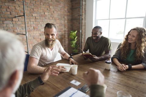 Adults holding a meeting in a conference room