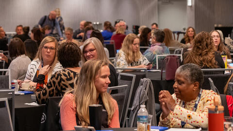 HCBS Innovation Grants Summit attendees talk with each other between presentations