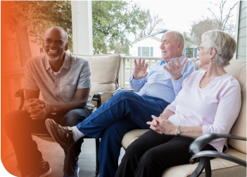 Three people talking on a porch