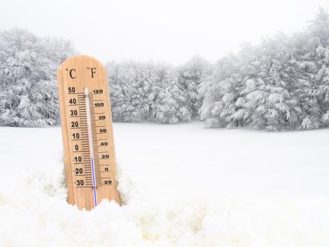 A thermometer in the snow showing the temperature of -10 degrees C