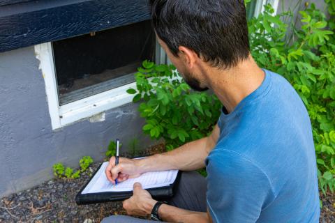 Building inspector checking basement windows