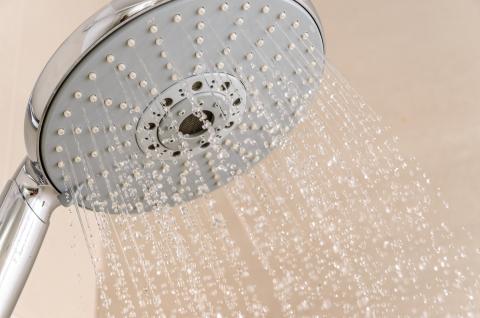 Side view of a running shower head