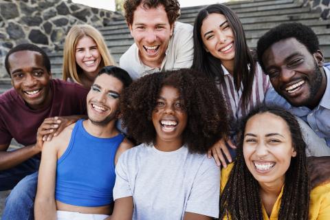 A group of eight young adults laughing