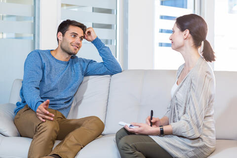 Patient on sofa talking to a psychologist