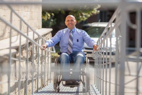 Person going up a ramp in a wheelchair