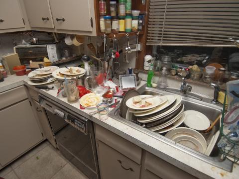 Counter and sink stacked full of dirty dishes
