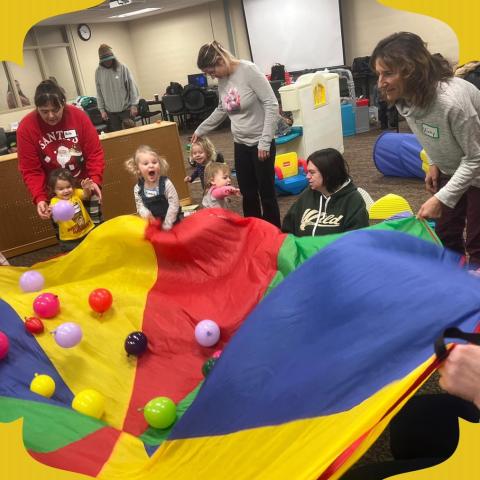 Dunn Birth to 3 ARPA Grants: Children playing with parachute