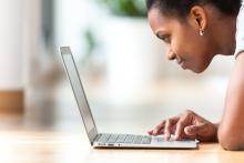 Close up of a person working with a laptop