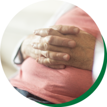 Close up of hands folded on stomach