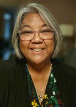 A head and shoulders portrait of Tina Childress smiling at the camera