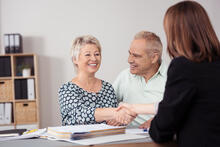 Happy Middle Aged Couple in Meeting