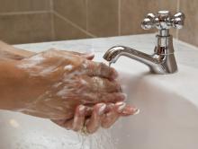 Washing hands with soap.