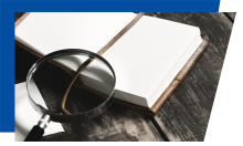 Partially open book with a magnifying glass
