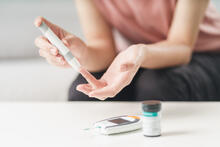 Person uses a lancet to draw blood to check blood sugar