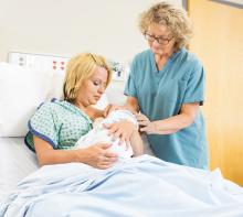 A baby is being breastfed at a hospital with a nurse.