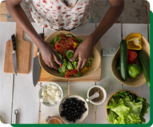 Adult prepping salad