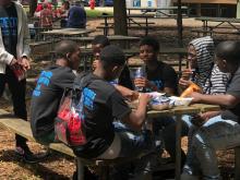 Boys eating at a picnic table