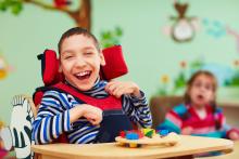 Laughing child in a wheelchair