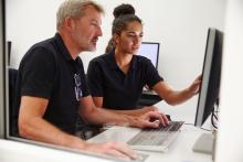 Two coworkers looking at a computer.