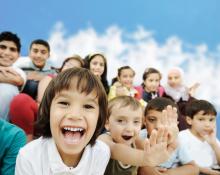 Children sitting outside smiling